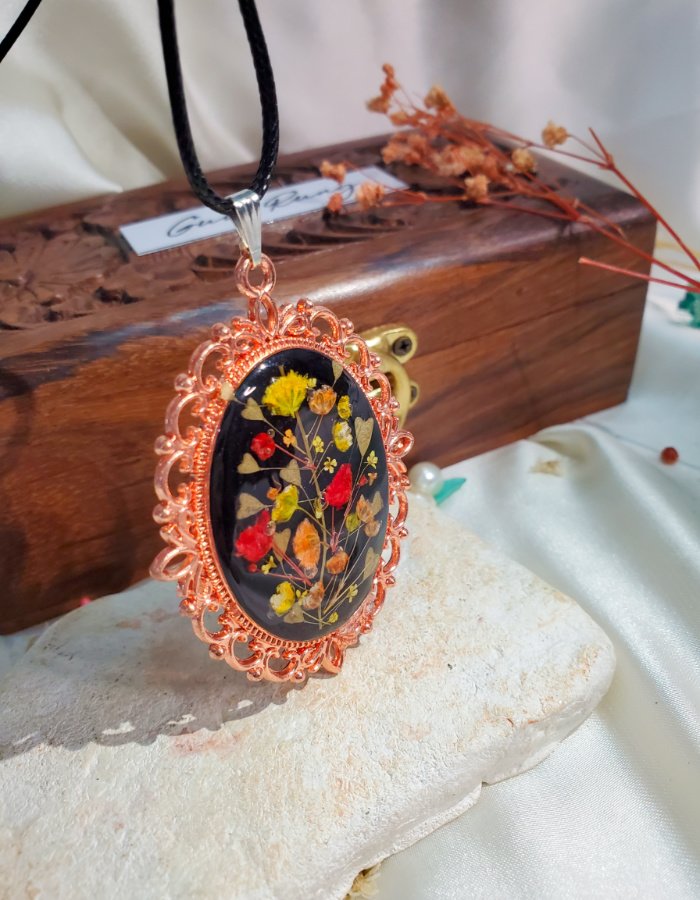 Gullrung hand-carved wooden gift box with the Zar-e-Rung preserved flower pendant on top