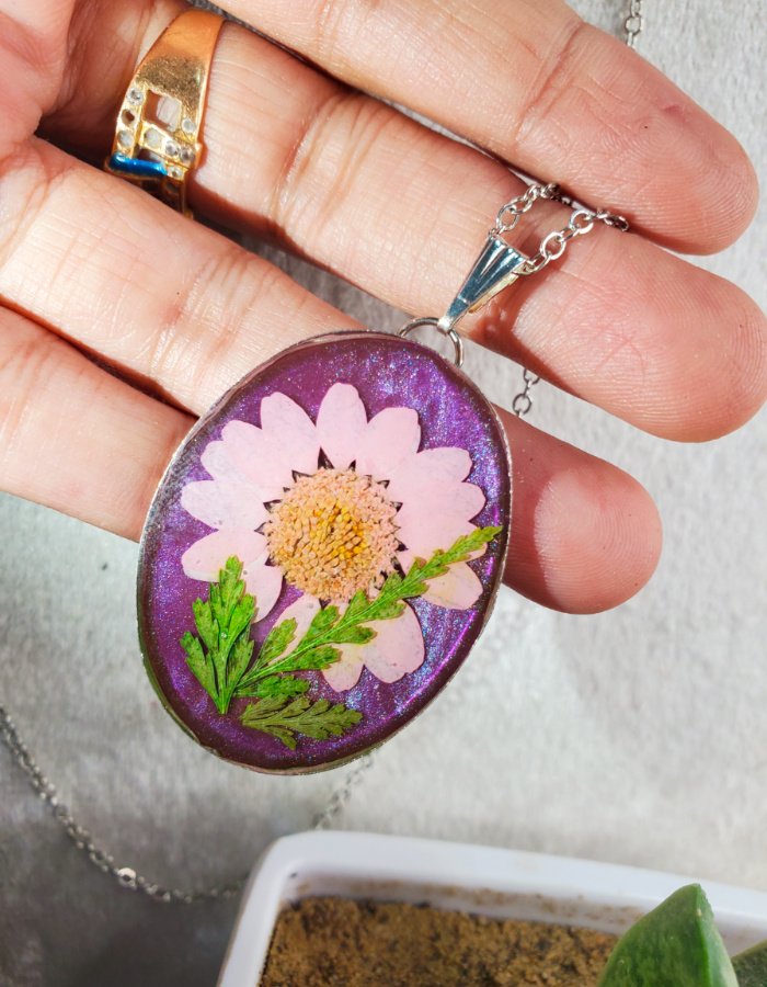 Mah-e-Shabnam Purple Daisy Pendant – handmade purple daisy pendant, held in hand to show size