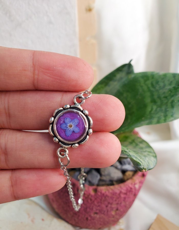 Niloofar‑e‑Firoza Purple Floral Bracelet – handmade purple flower charm bracelet, held in hand to show size