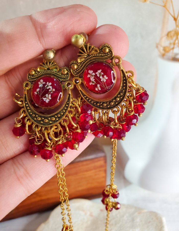 Zar‑e‑Anjum Red Floral Earrings – handmade resin flower earrings, worn in hand