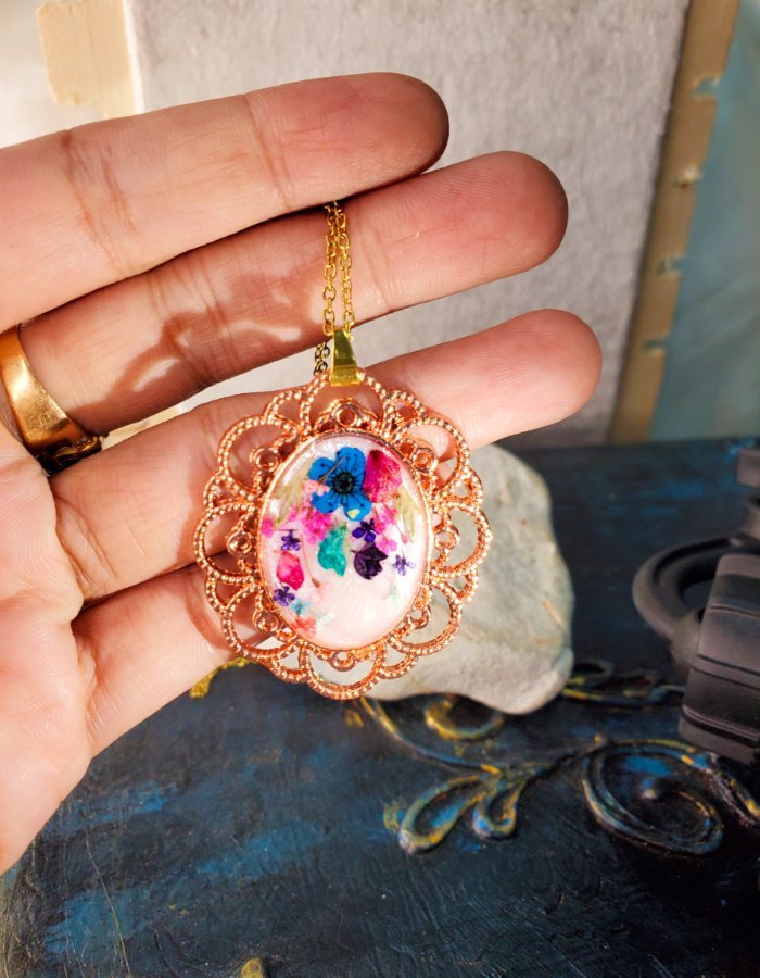 Zar‑e‑Gulistan White Multi Floral Pendant – handmade filigree flower pendant, held in hand to show size