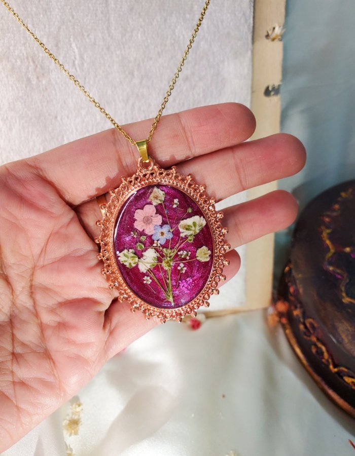 Zar‑e‑Nazakat Pink Floral Pendant – handmade rose gold flower pendant, held in hand to show large size